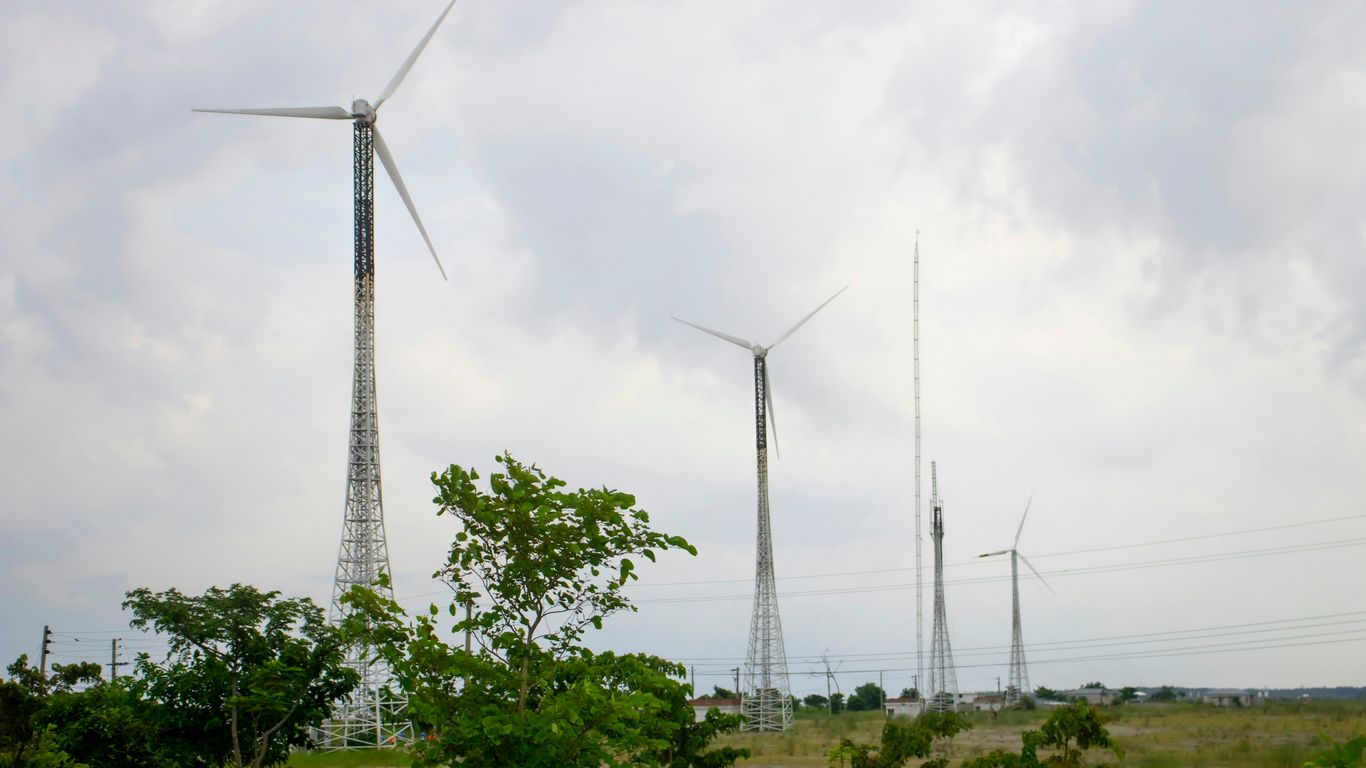 a group of wind turbines on a cloudy day