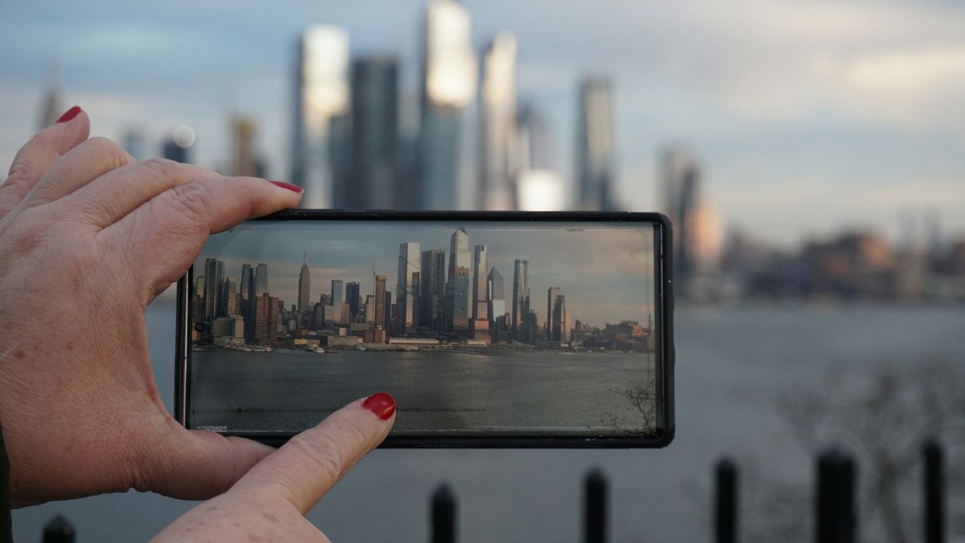 A person taking a picture with a cell phone