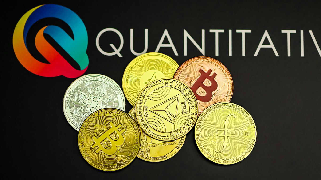 a pile of coins sitting next to a quatitive logo