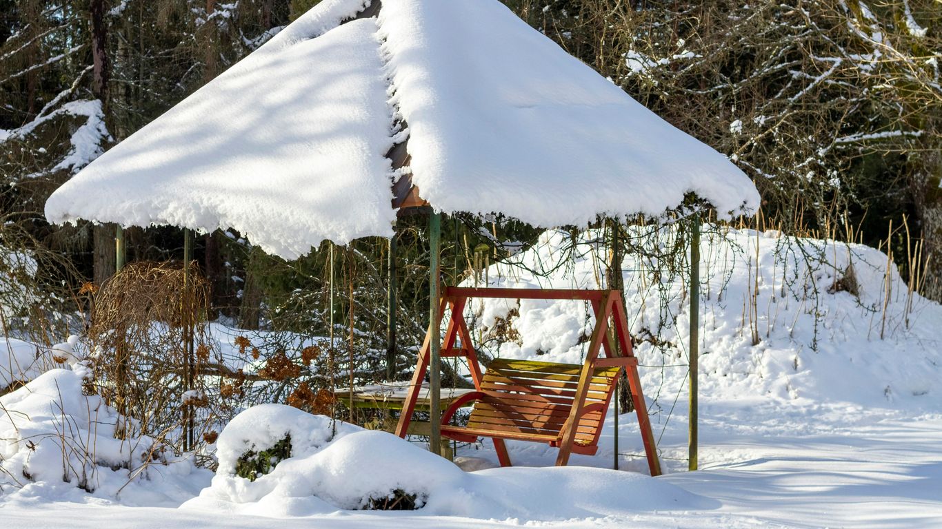 brown wooden swing covered with snow
