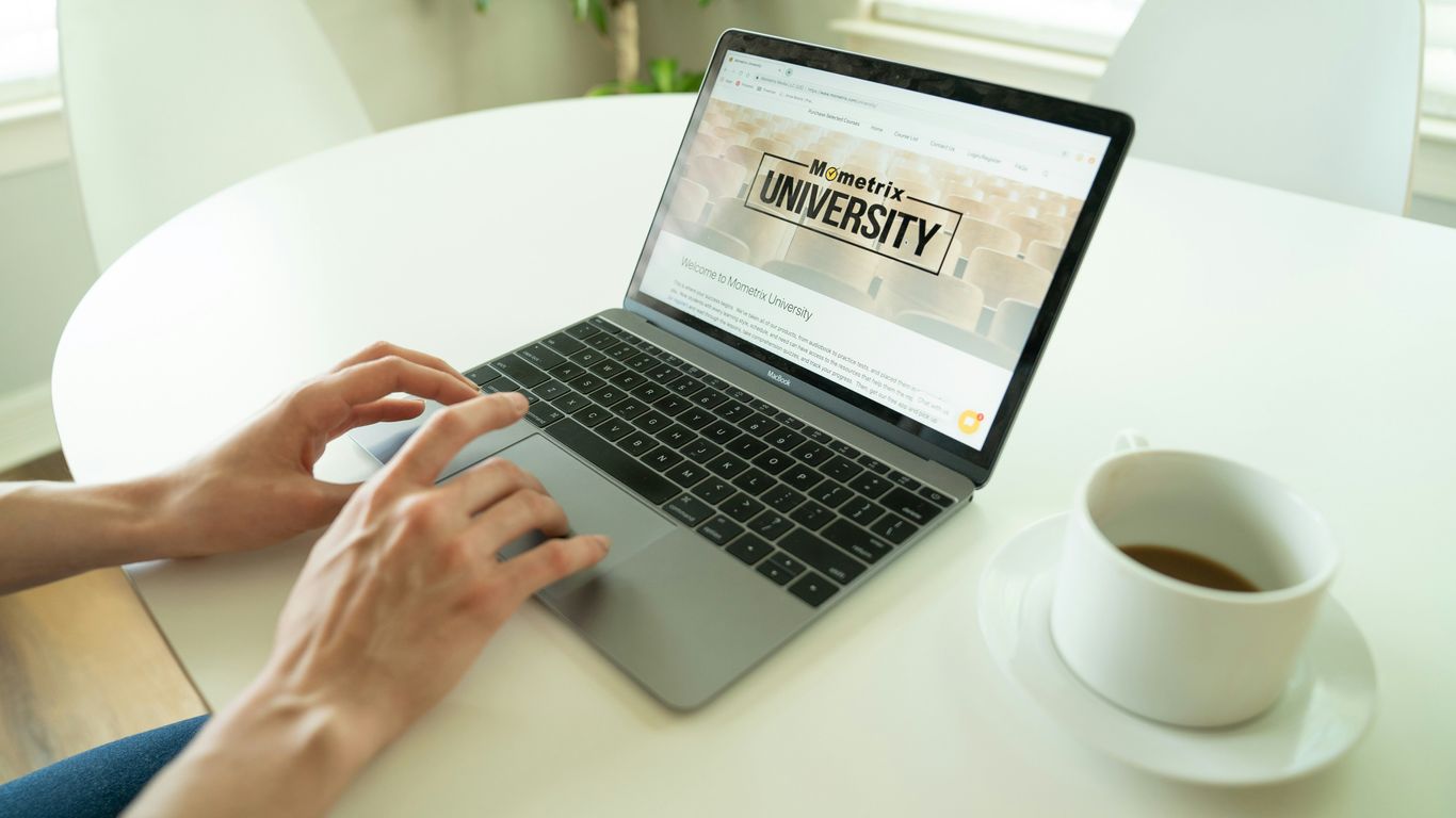 black and gray laptop beside teacup