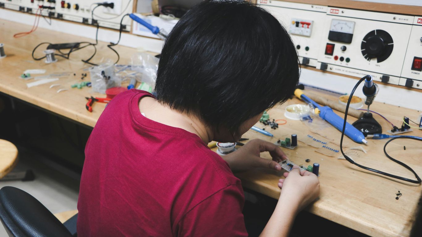 woman sitting beside brown wooden table