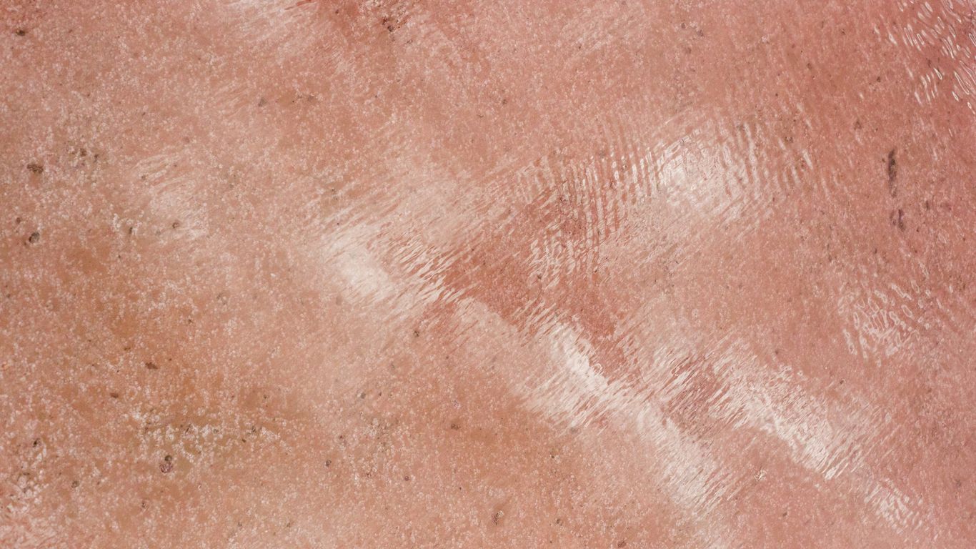 Textured pink surface with a reflective shine.