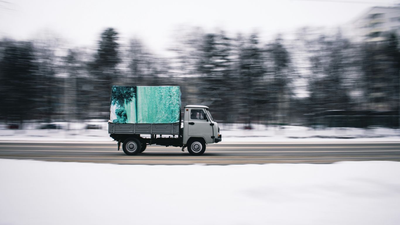 time lapse photography of white cab forward truck surrounded by snow
