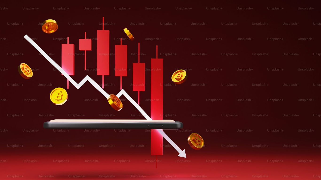 A smartphone displaying a declining financial graph with coins.