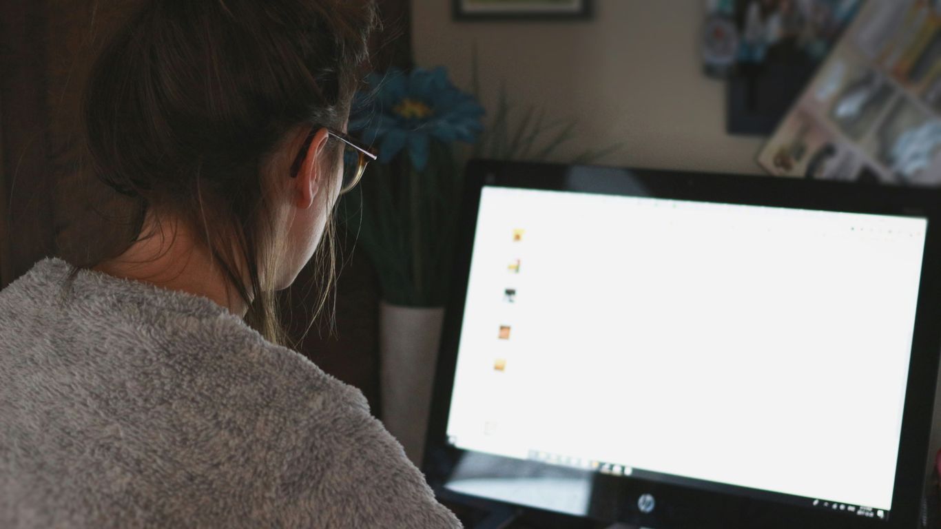 woman in front of computer monitor