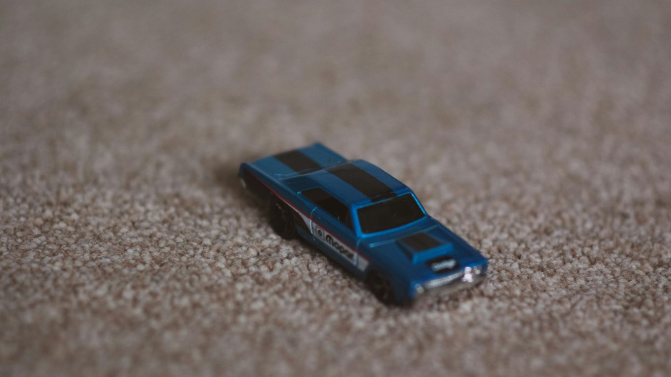 a toy car is laying on the floor