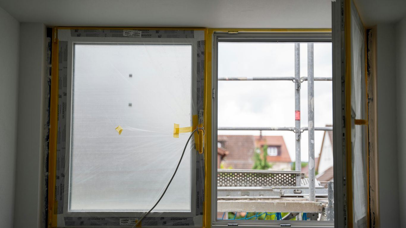 Open window with construction happening outside.
