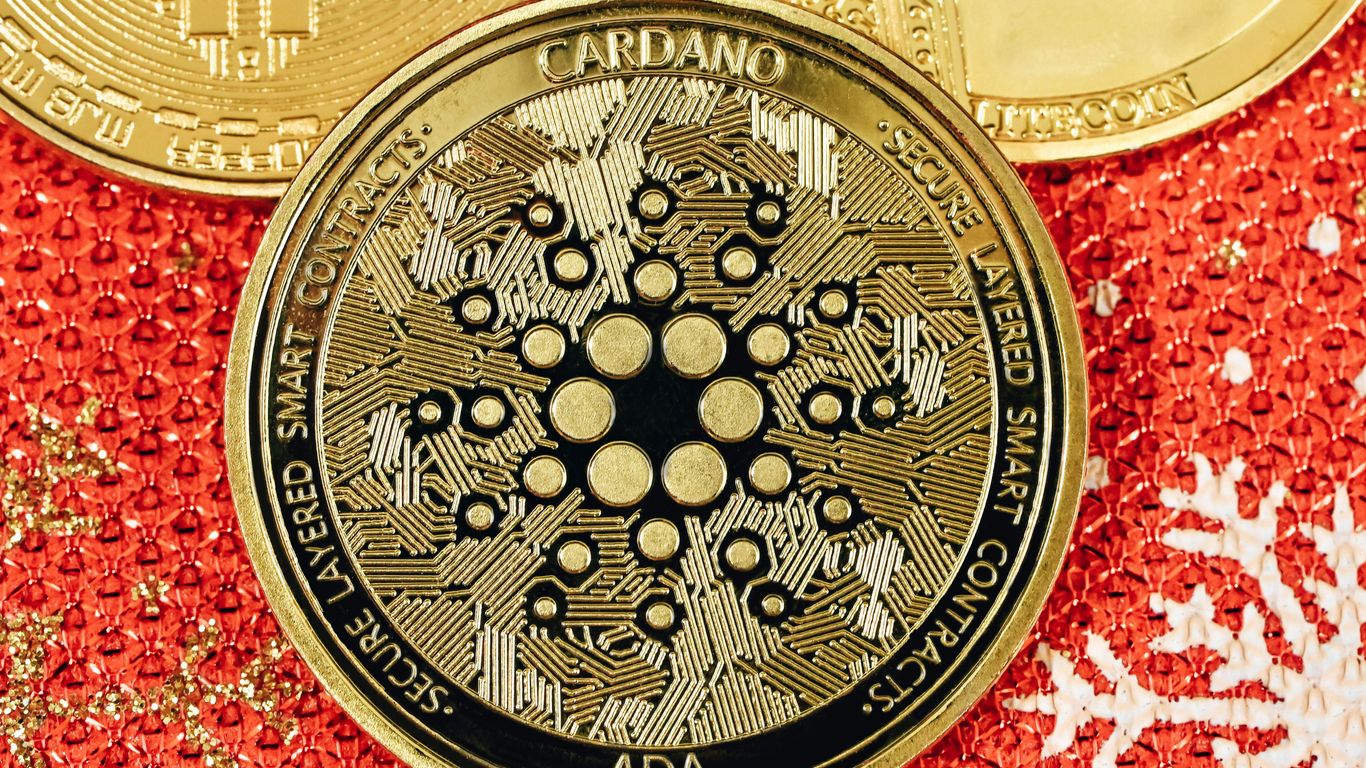 A close-up of a Cardano cryptocurrency coin on a surface.