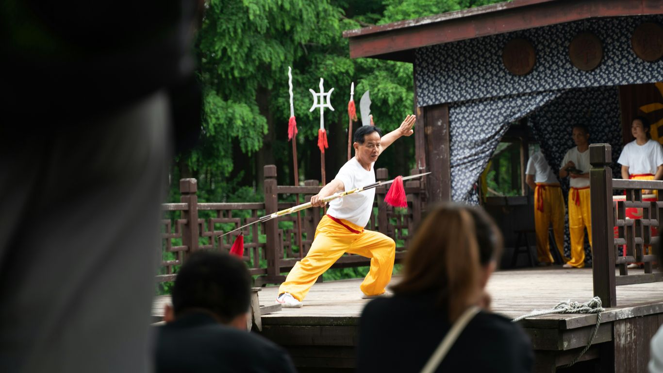 A man in yellow pants holding a baseball bat