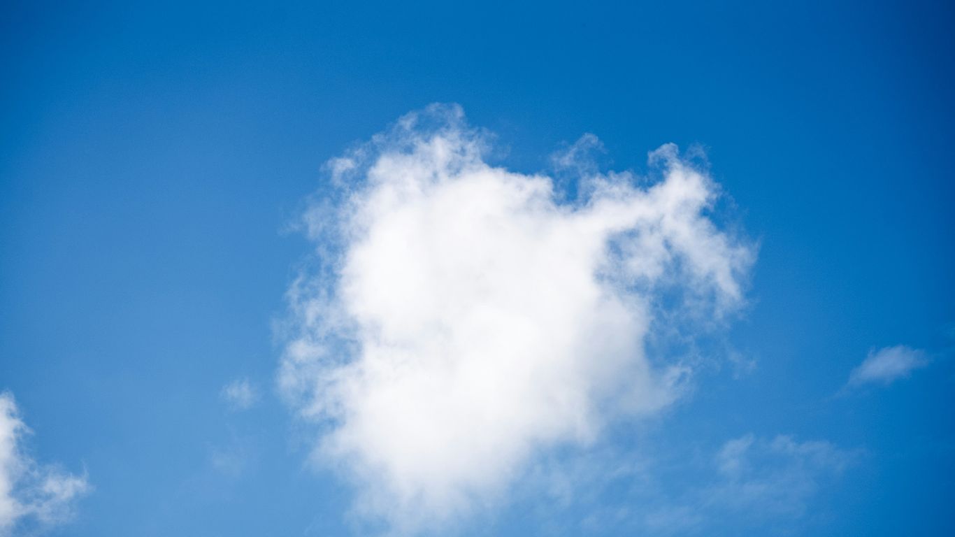 a white cloud in a blue sky