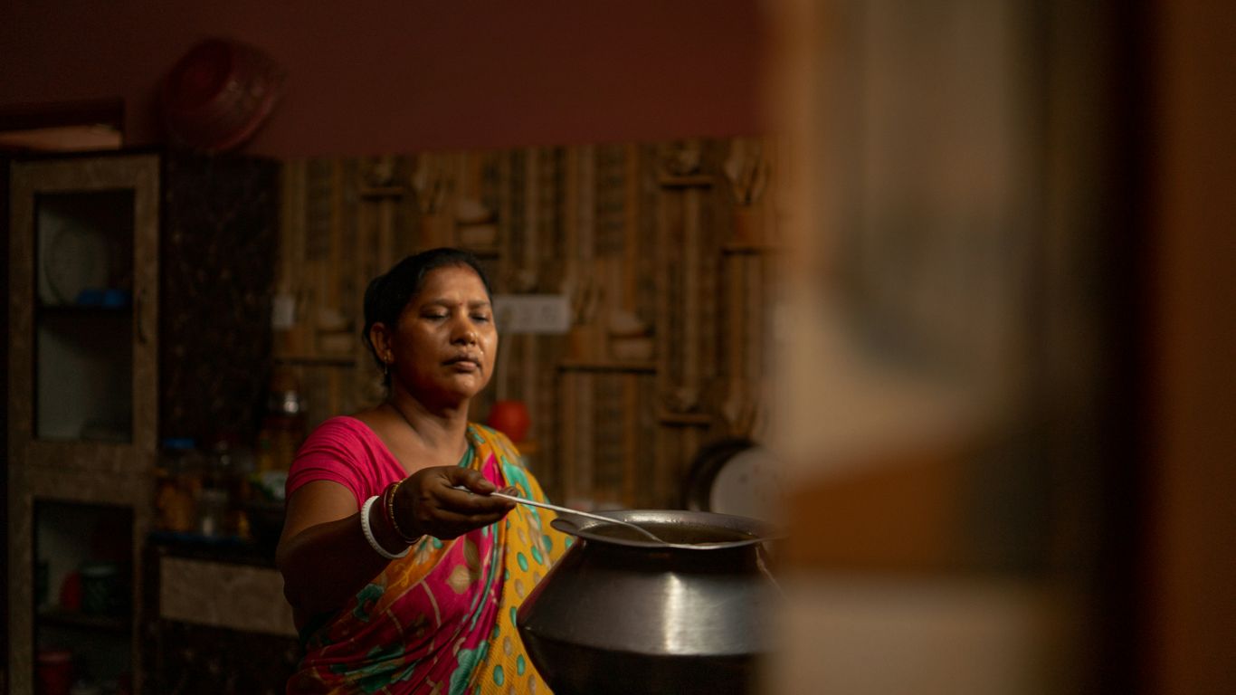 a woman stirring a pot on a stove