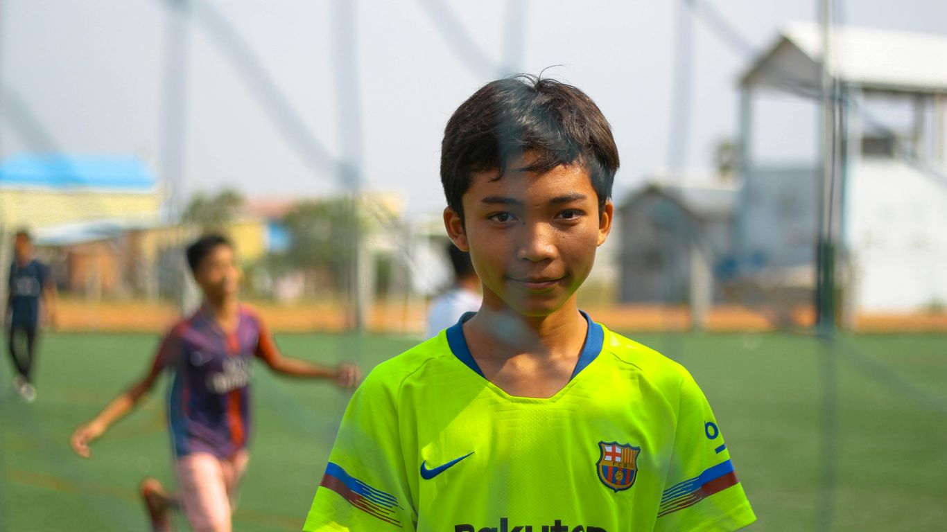 boy standing near net goal