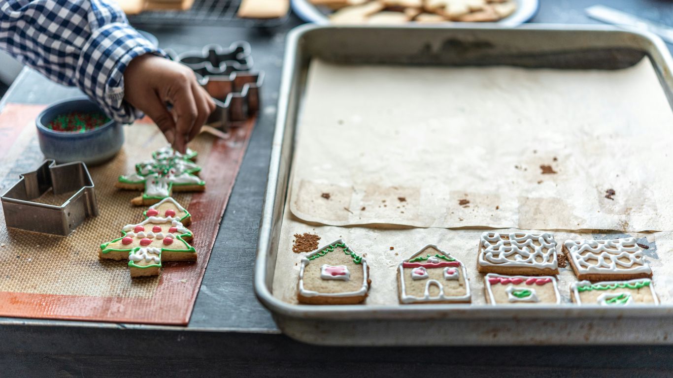 a person decorating cookies on a table