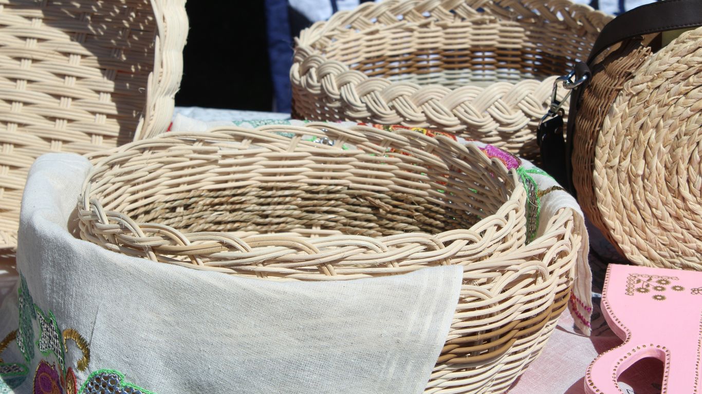brown woven basket on gray textile