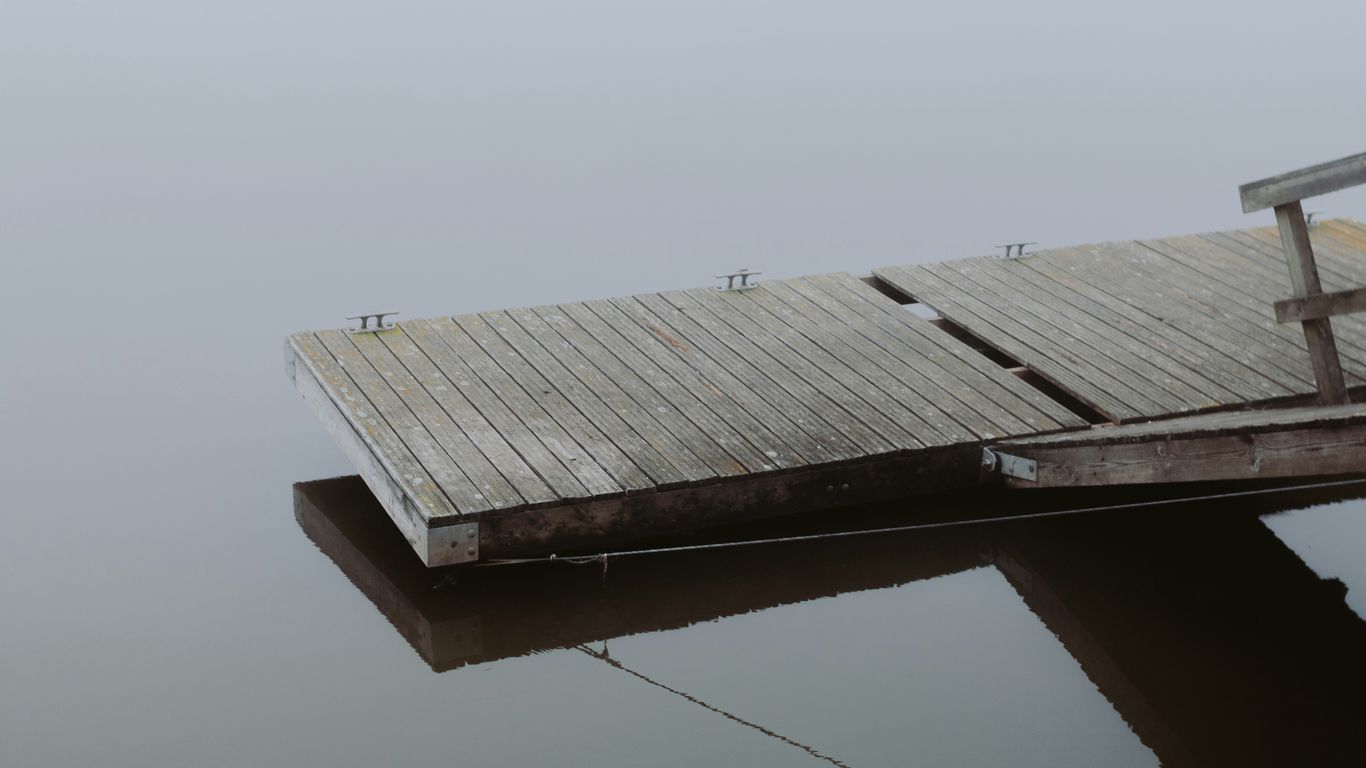 brown wooden dock on body of water during daytime