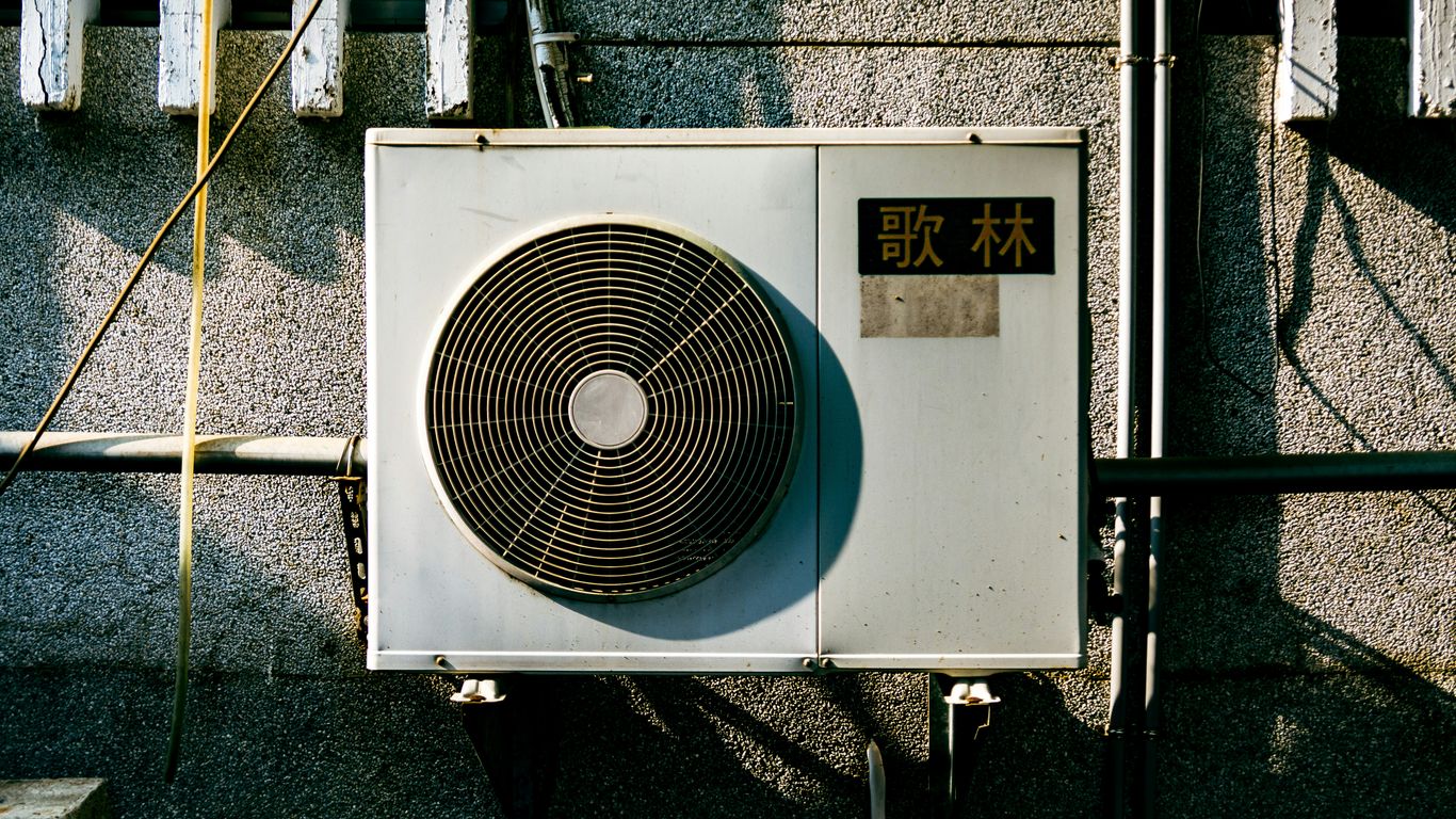 a wall mounted air conditioner mounted on the side of a building