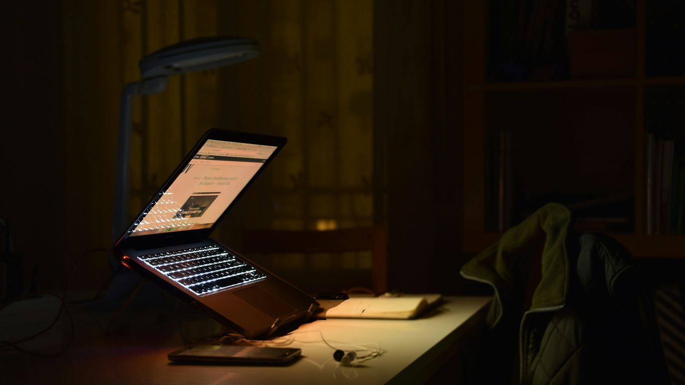 gray laptop computer turned on while in tilting position