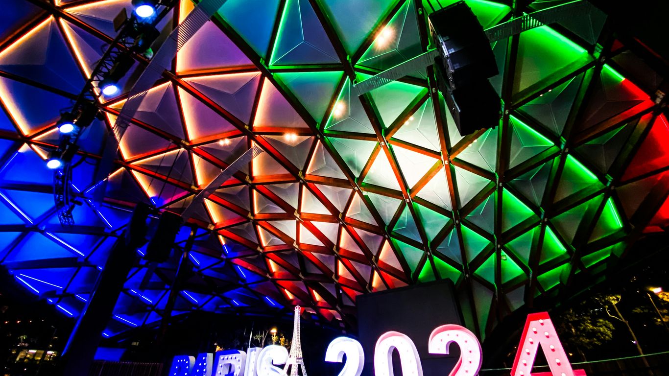 A large colorful building with a sign underneath it