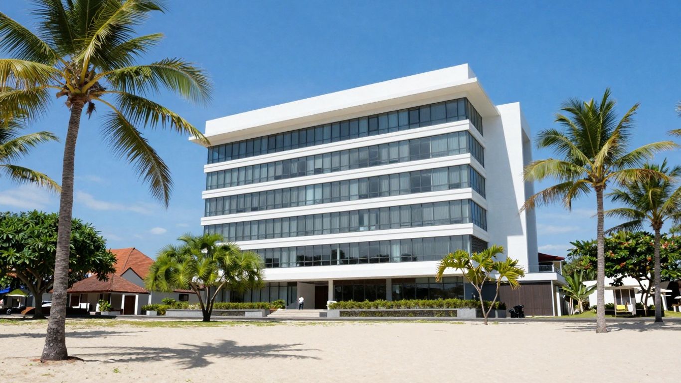 Balinese beach with office building and palm trees.