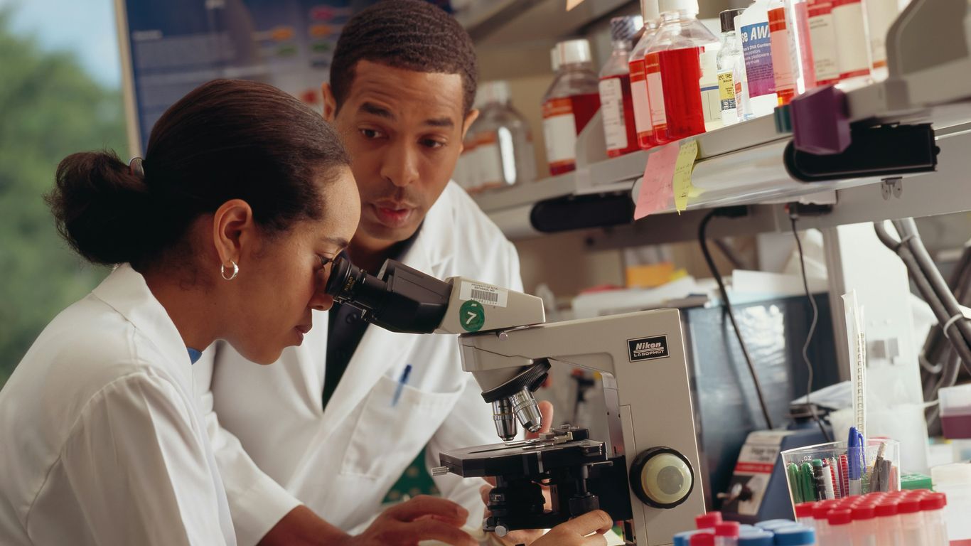 man in white chef uniform holding black and silver power tool