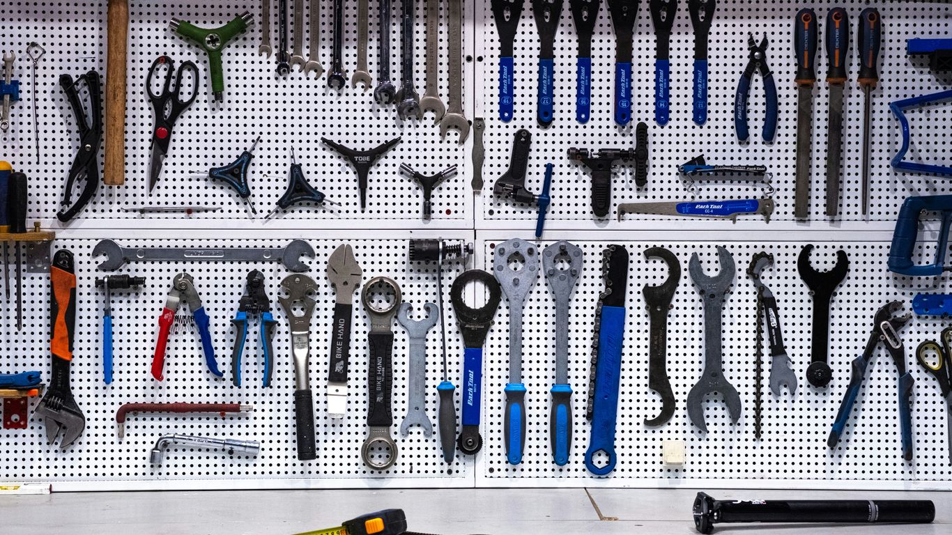 a bunch of tools hanging up on a wall