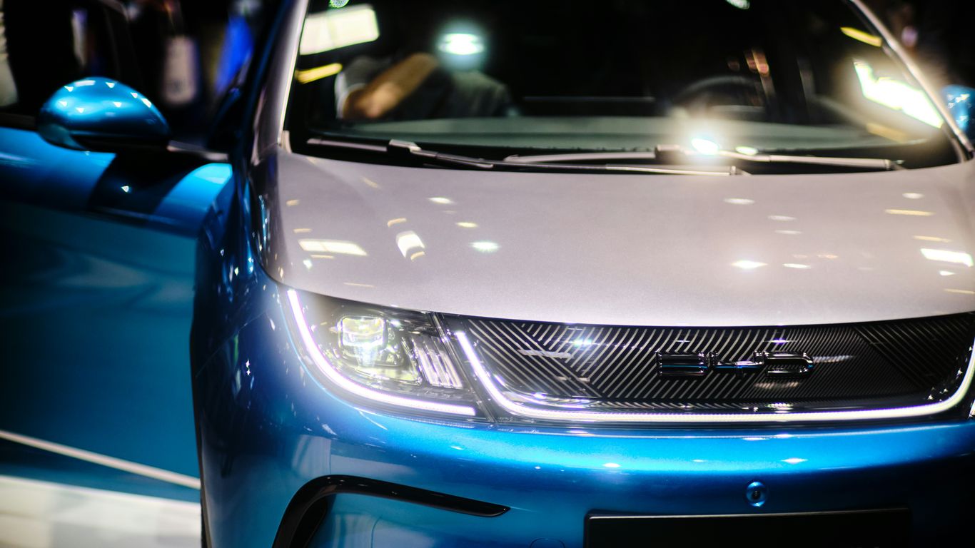 a close up of the front of a blue and white car