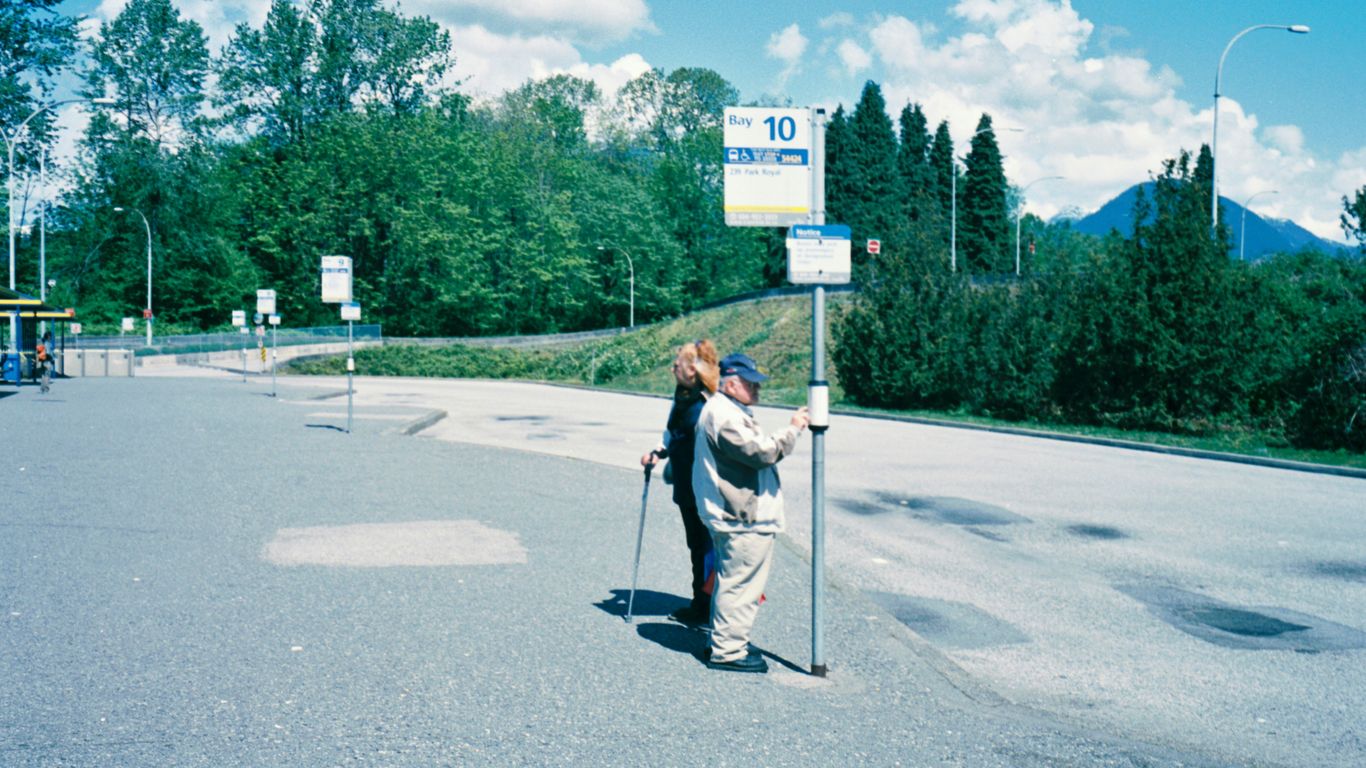 man in white shirt and black pants holding black stick