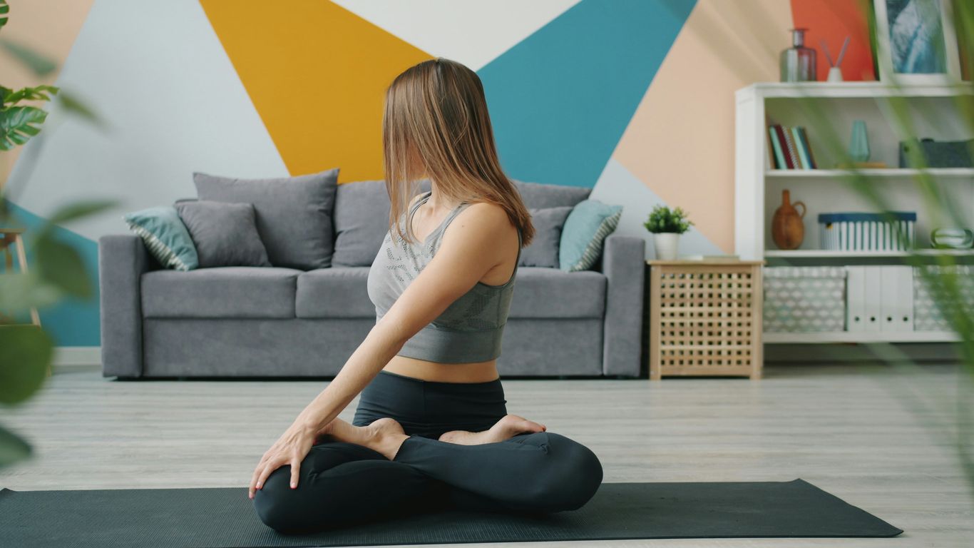 Woman doing a yoga twist on a mat