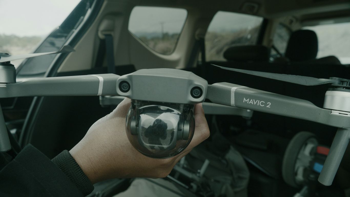 a person holding a camera in a vehicle