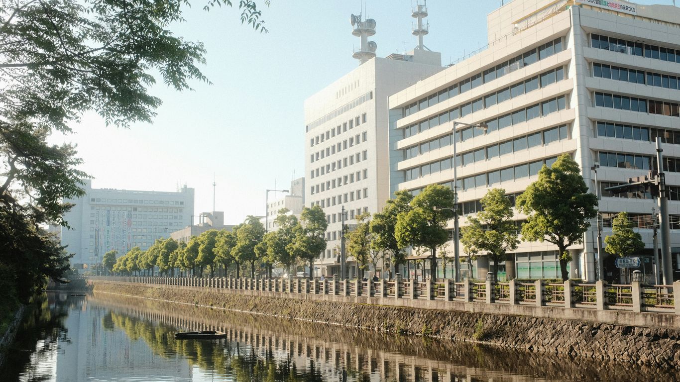 a river running through a city next to tall buildings