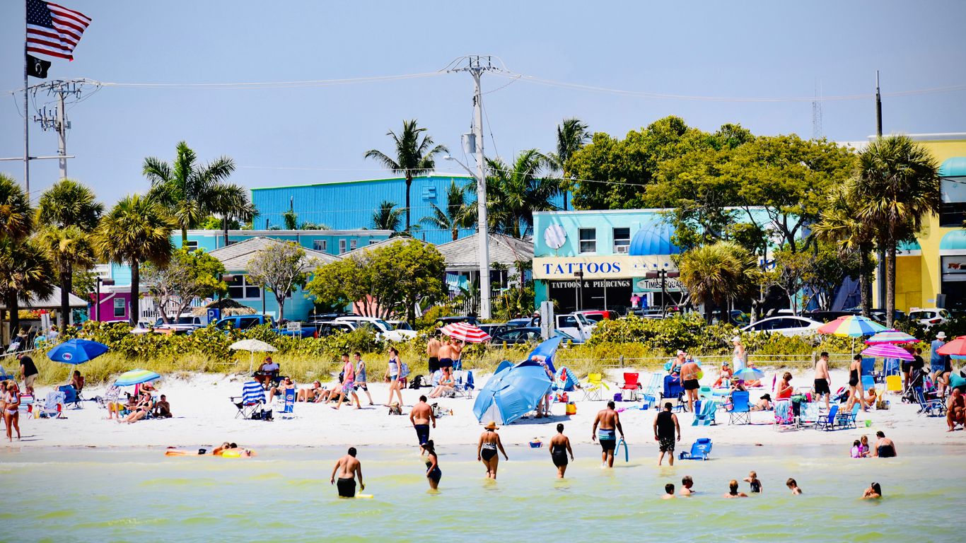 people at the beach near buildings