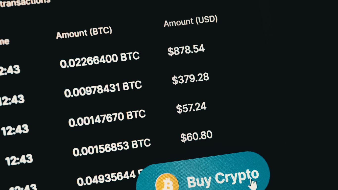 Screen displaying cryptocurrency transactions and a "Buy Crypto" button.