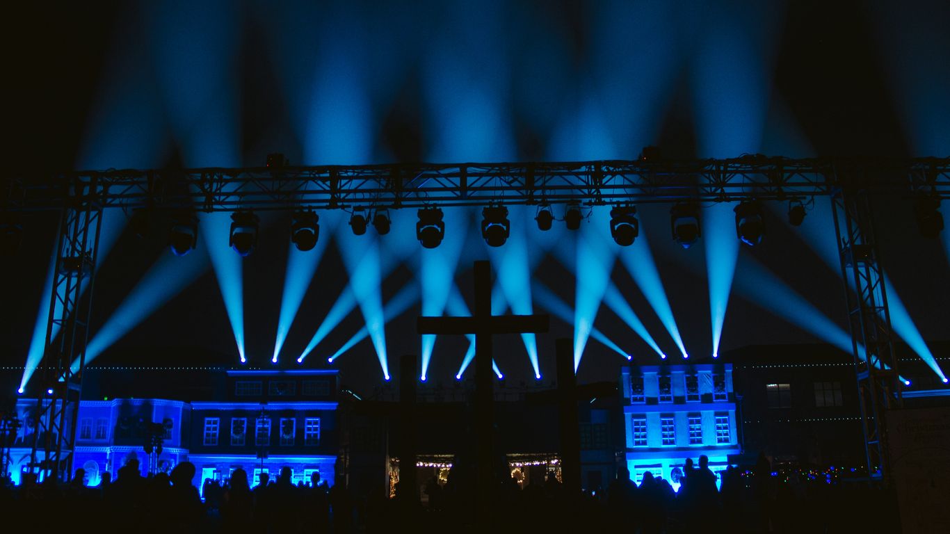a stage lit up with blue lights at night