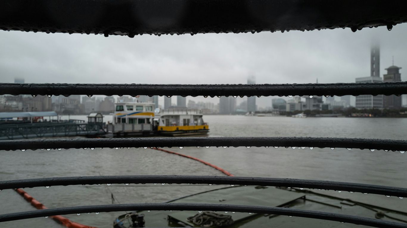 a boat traveling down a river next to a bridge