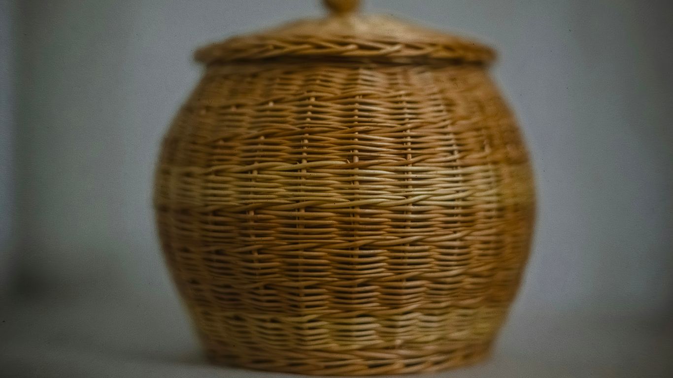 A wicker basket with a lid on a table