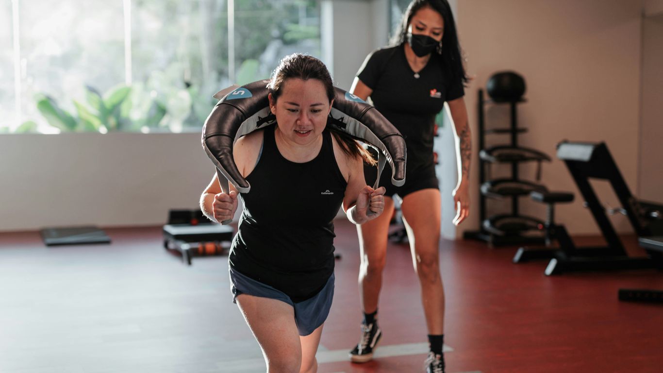 woman exercising with personal trainer