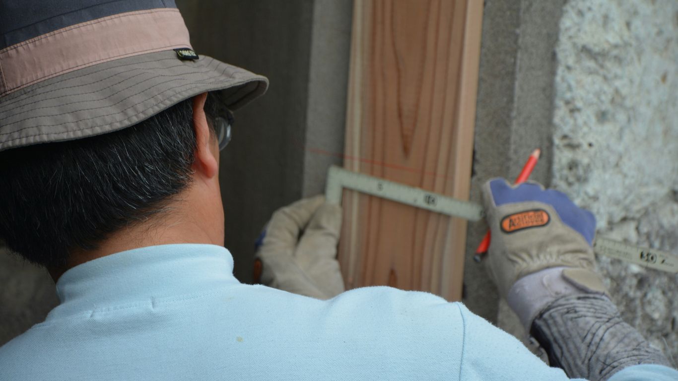 man in white shirt and black hat holding gray and red toy gun
