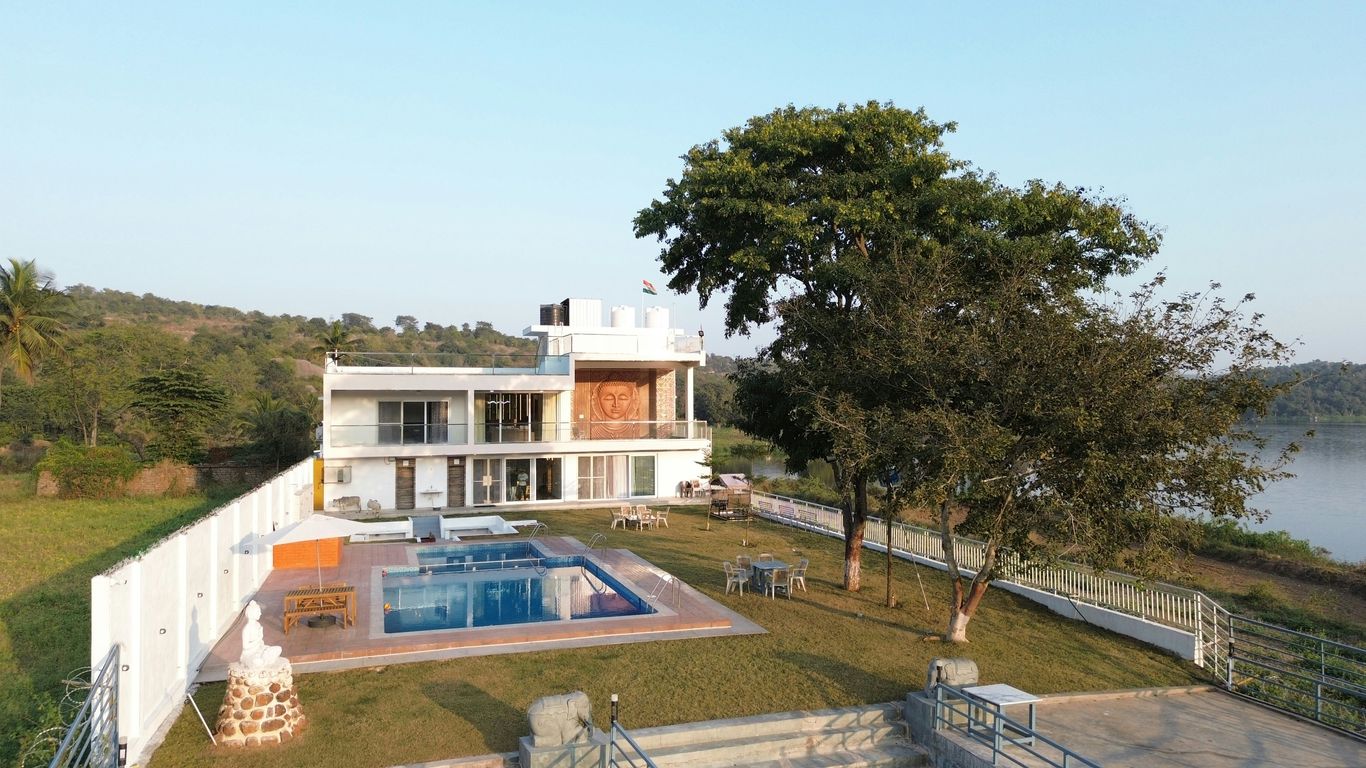 Modern house with a pool next to a lake.
