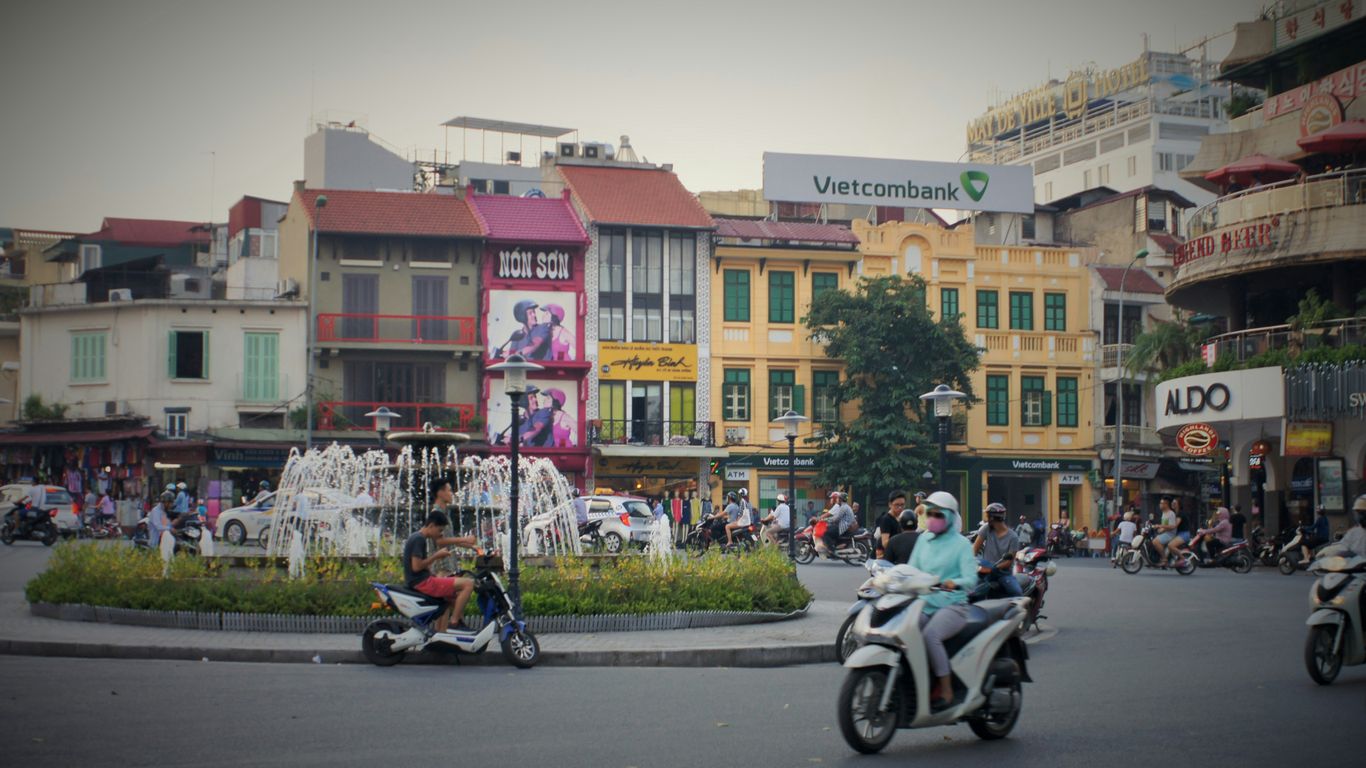 a group of people riding scooters down a street