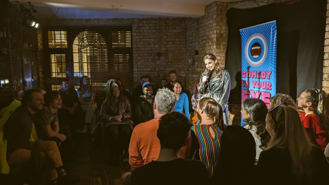 A comedian performs for an attentive audience at a comedy club.