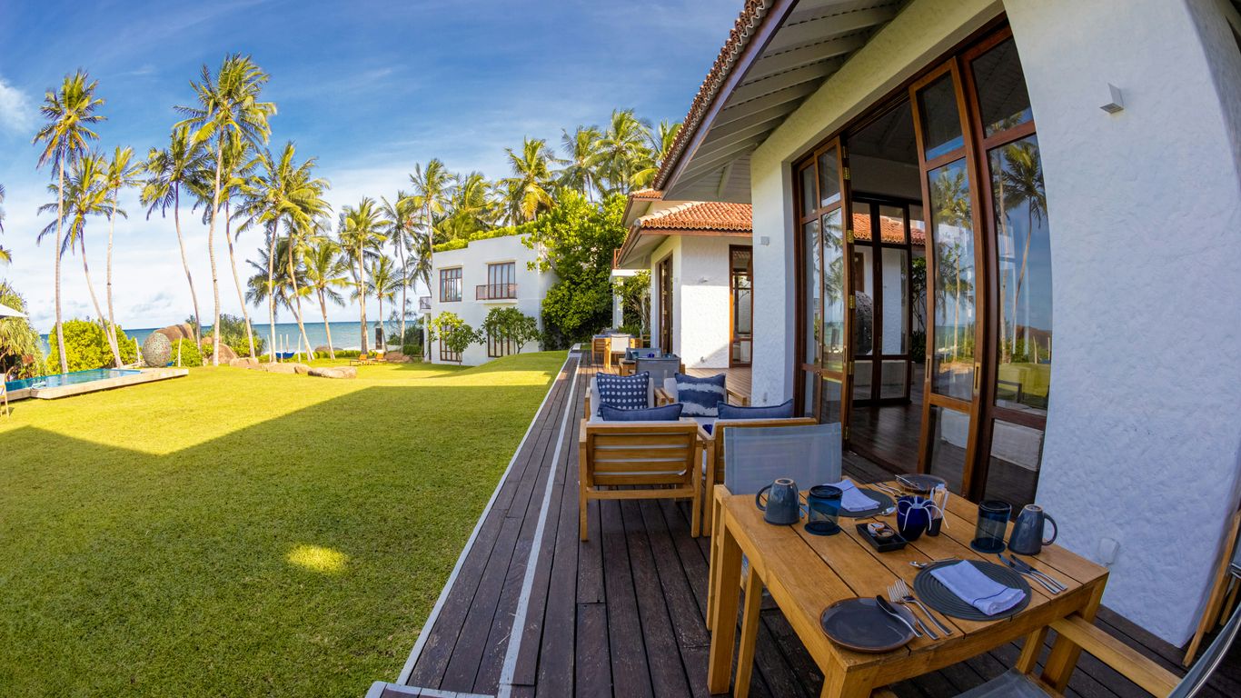 a wooden table sitting on top of a lush green field