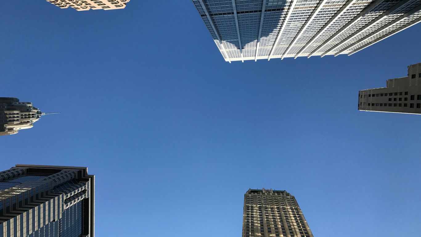low angle photography of white and brown high-rise buildings during daytime