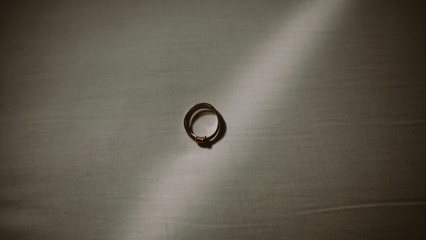 silver ring on gray textile