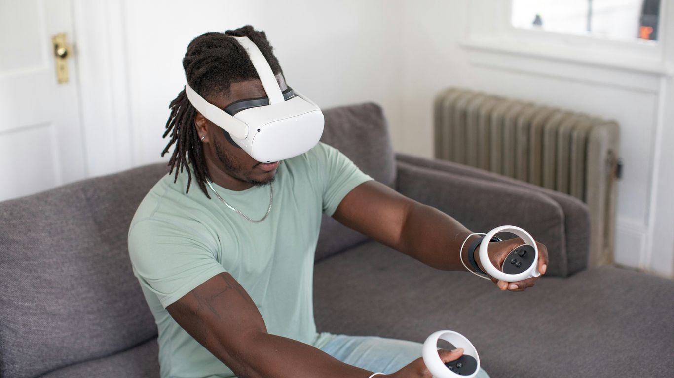 a woman wearing a mask and holding a game controller