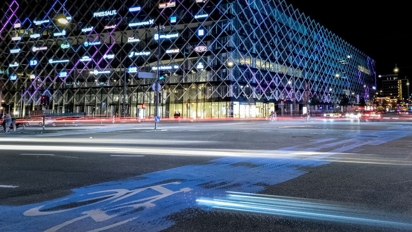 Modern building with light trails at night
