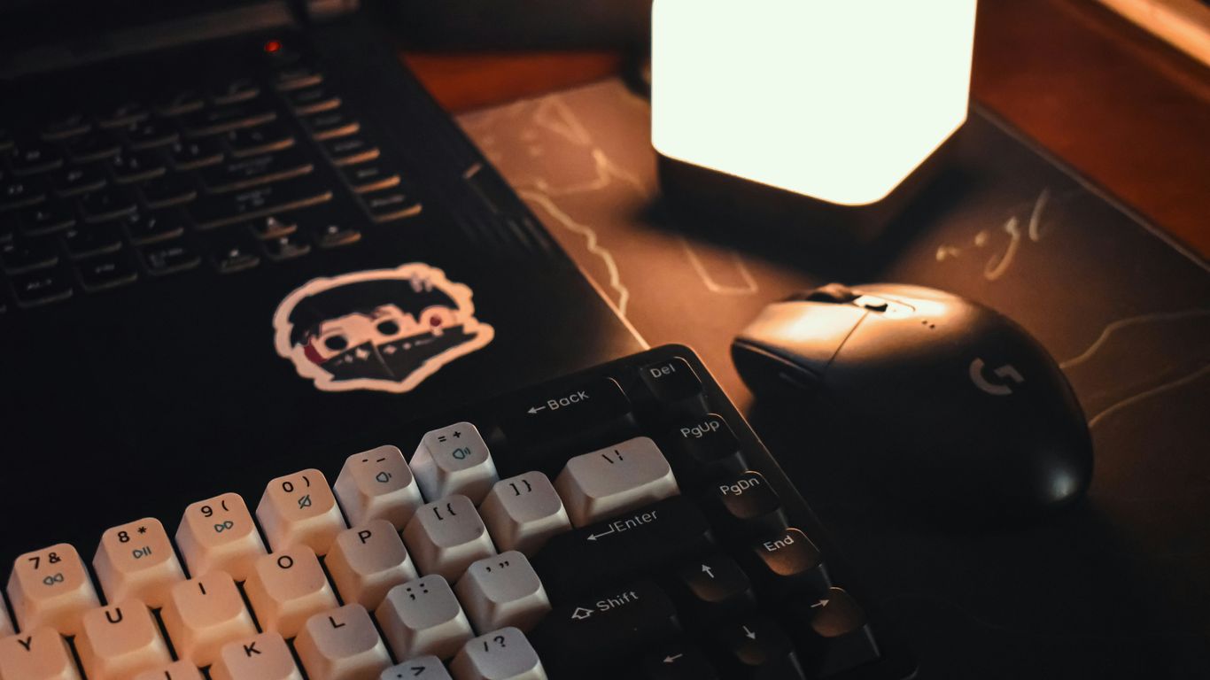 a computer keyboard sitting next to a computer mouse