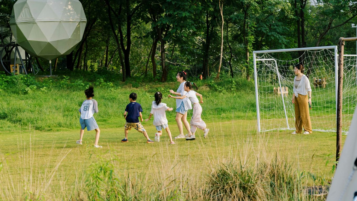 A group of people playing a game of soccer