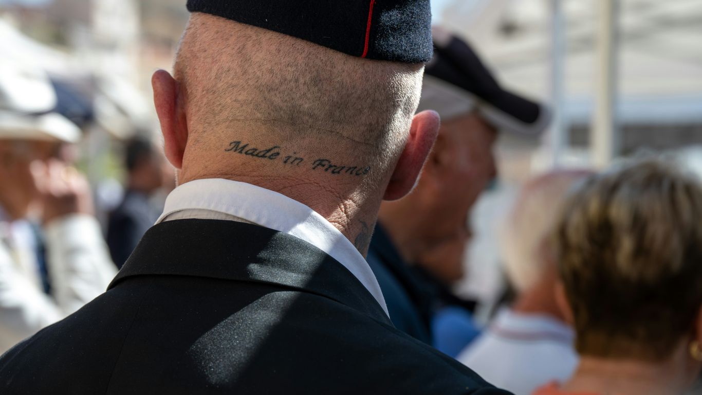 A man in a military uniform standing in a crowd