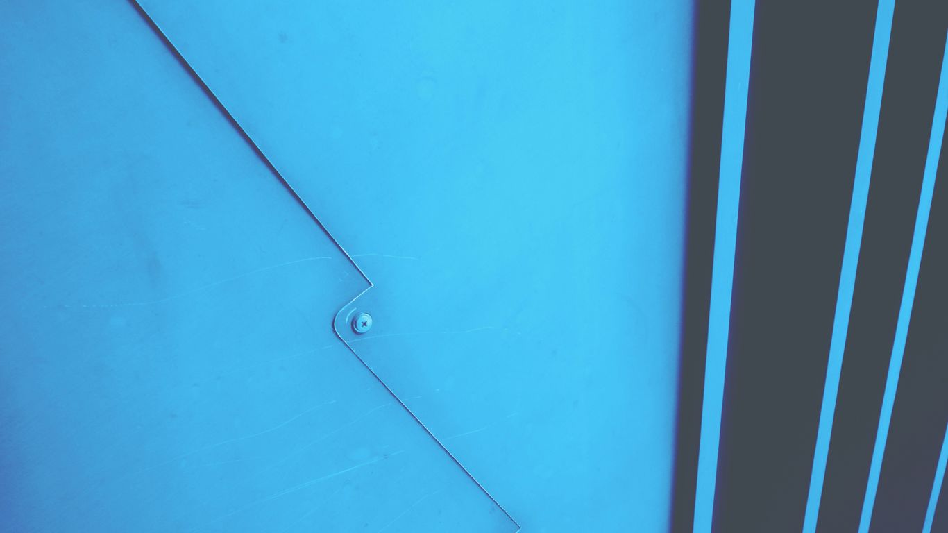 a blue wall with a hole in it